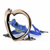 Infatuation Frogman bronze by Tim Cotterill featuring blue frog within gold heart sculpture